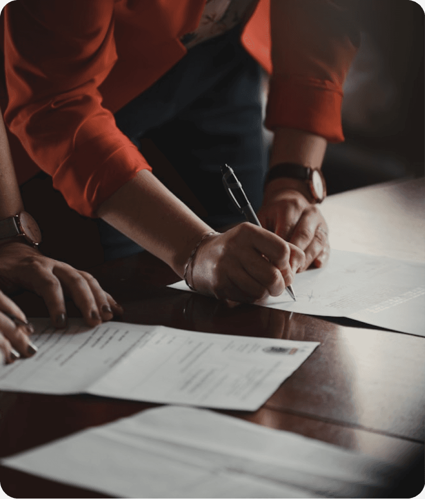 Business owners reviewing and signing corporate documents